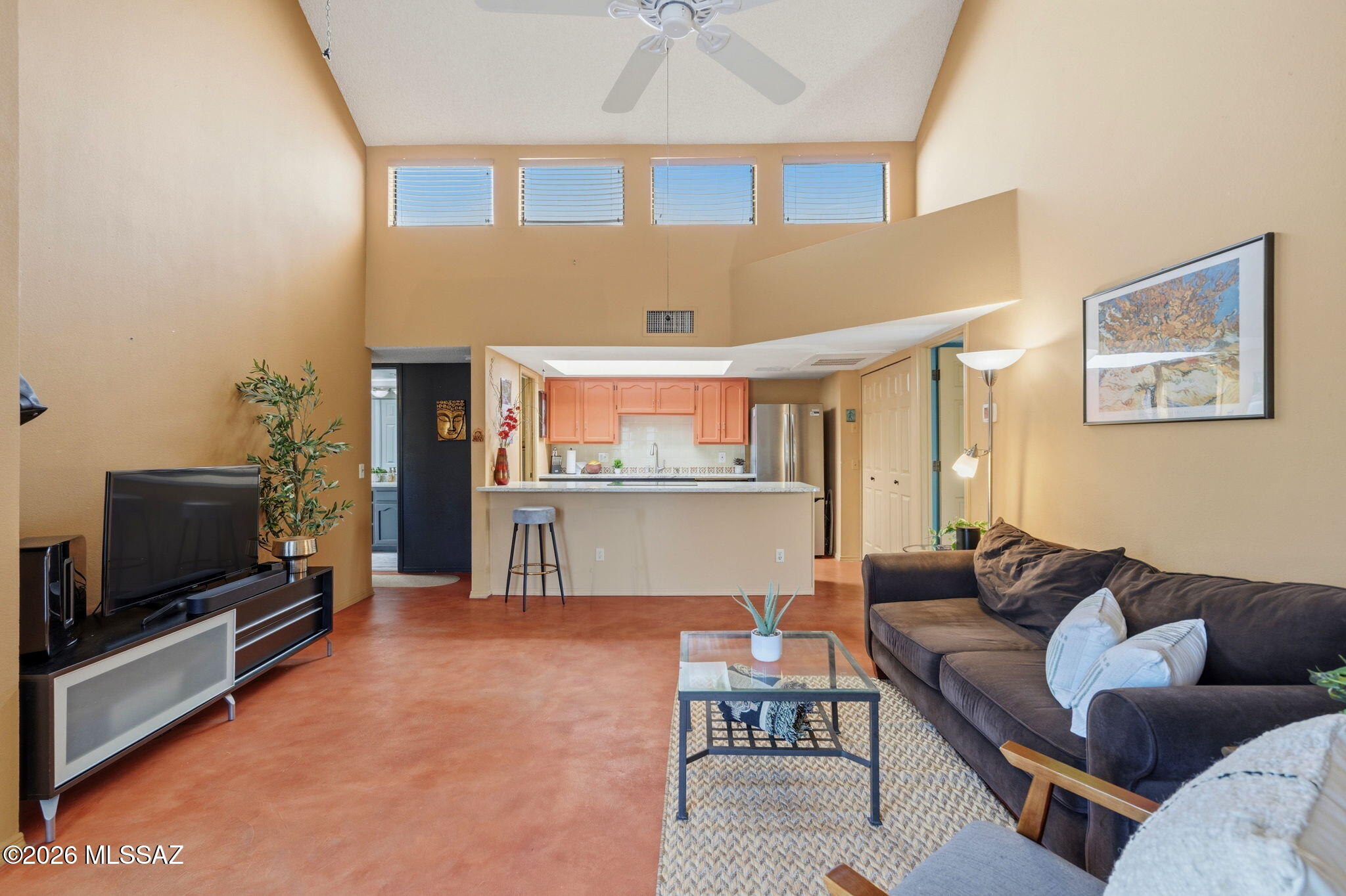 1200 East River Road, Unit G87 Tucson, AZ 85718 - Photo 7 of 30 a living room with furniture and a flat screen tv