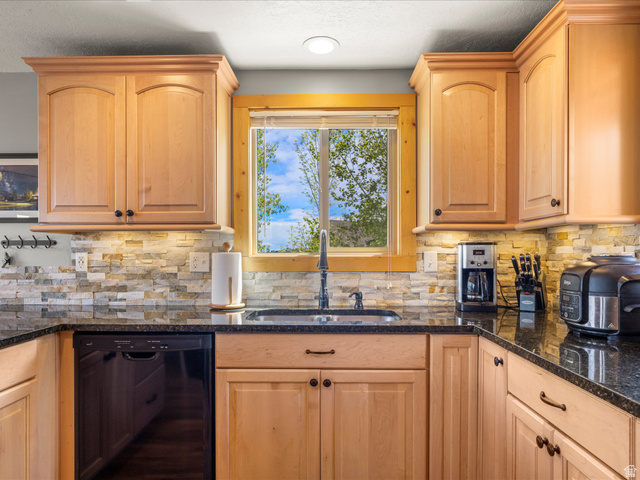 371 Lewis Loop, Unit 29 Fish Haven, ID 83287 - Photo 23 of 40 Kitchen featuring light wood cabinetry with arch panel doors and dark hardware, granite countertops, and a stacked stone backsplash