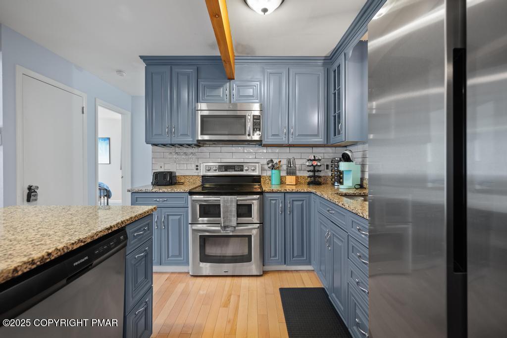 1345 Highway 715 Stroudsburg, PA 18360 - Photo 9 of 35 a kitchen with stainless steel appliances granite countertop a stove a sink and a refrigerator