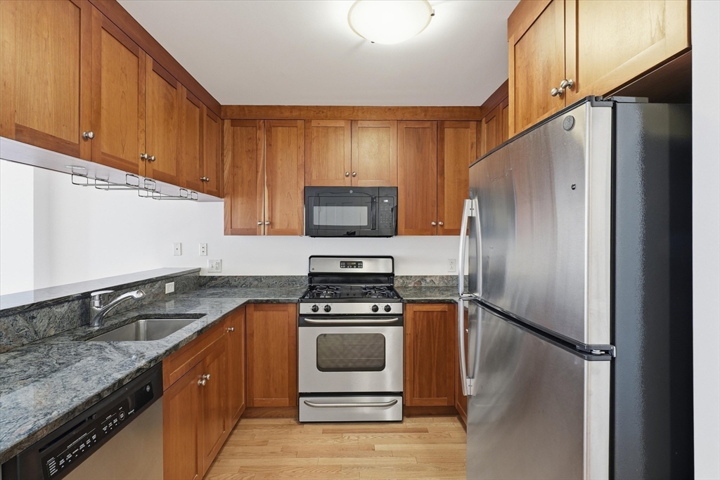 2-14 St Paul Street, Unit 403 Brookline, MA 02446 - Photo 4 of 16 a kitchen with a refrigerator sink and stove
