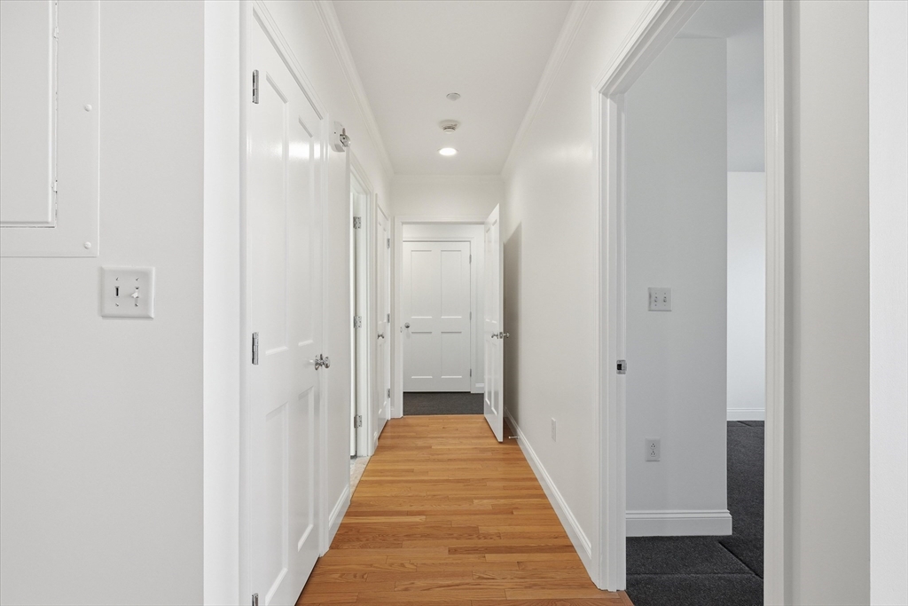 2-14 St Paul Street, Unit 403 Brookline, MA 02446 - Photo 5 of 16 a view of a hallway with a white walls