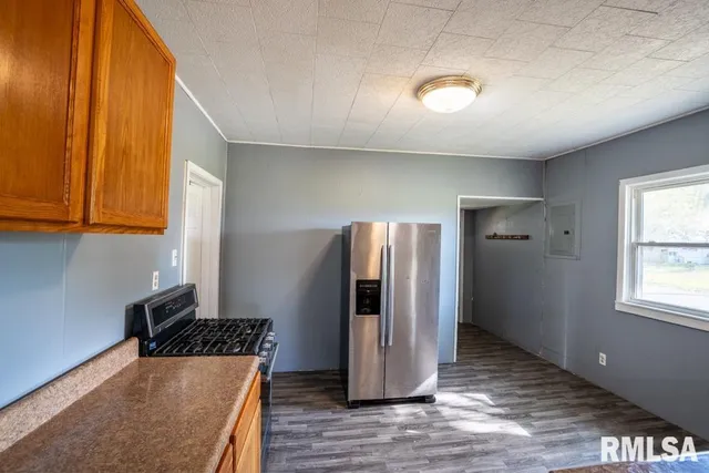 a kitchen with refrigerator and window