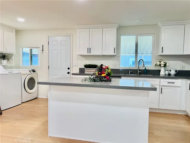a kitchen with a refrigerator and cabinets