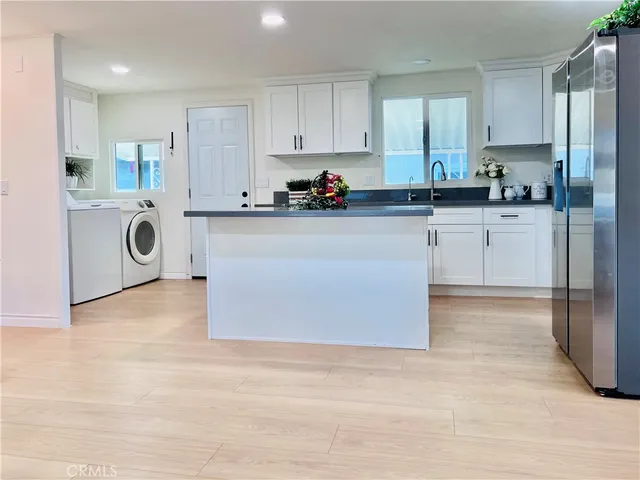 a kitchen with a refrigerator and cabinets