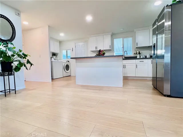 a view of a storage and utility room with washer and dryer