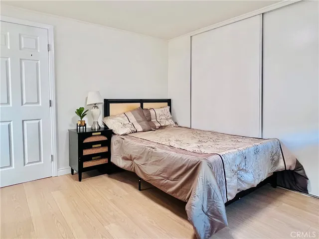 a bedroom with a bed and a potted plant
