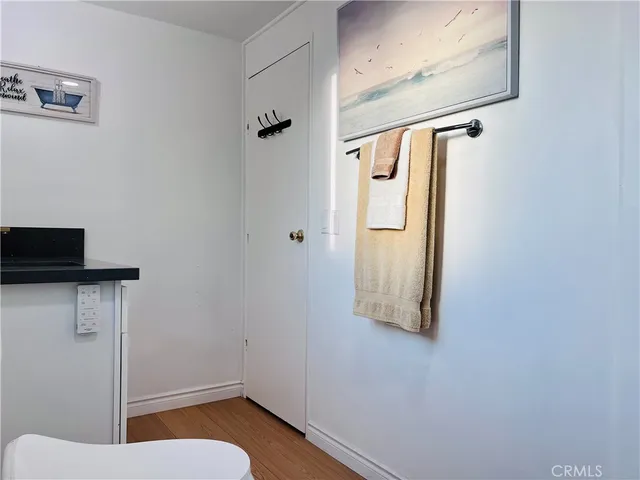 a bedroom with a bed and painting on the wall