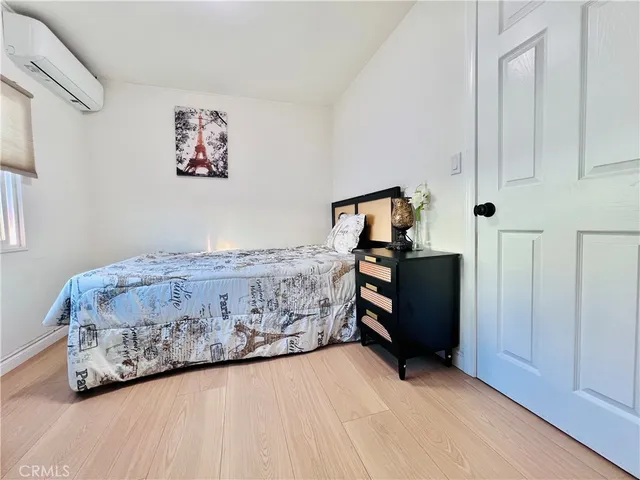 a bedroom that has a bed and a chair in it