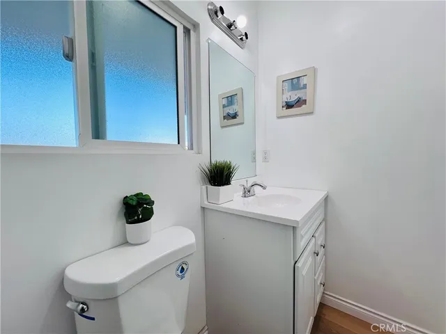 a front view of a house with a yard and potted plants