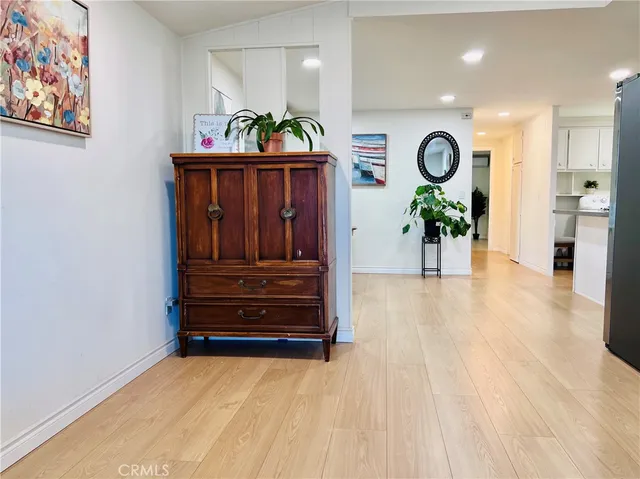 a view of a kitchen with furniture and a potted plant