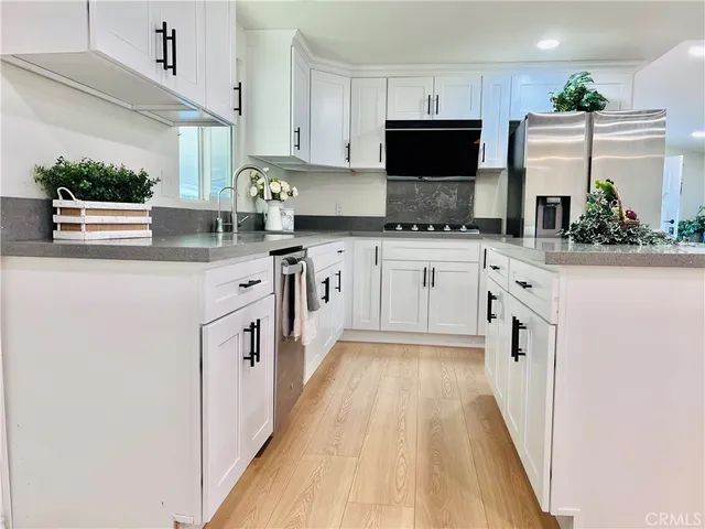 a kitchen with a sink a stove and cabinets