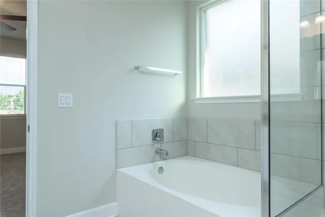 a white bath tub sitting next to a window