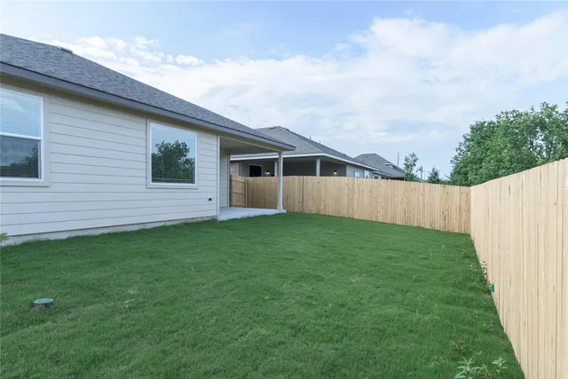 a view of an house with backyard space and garden
