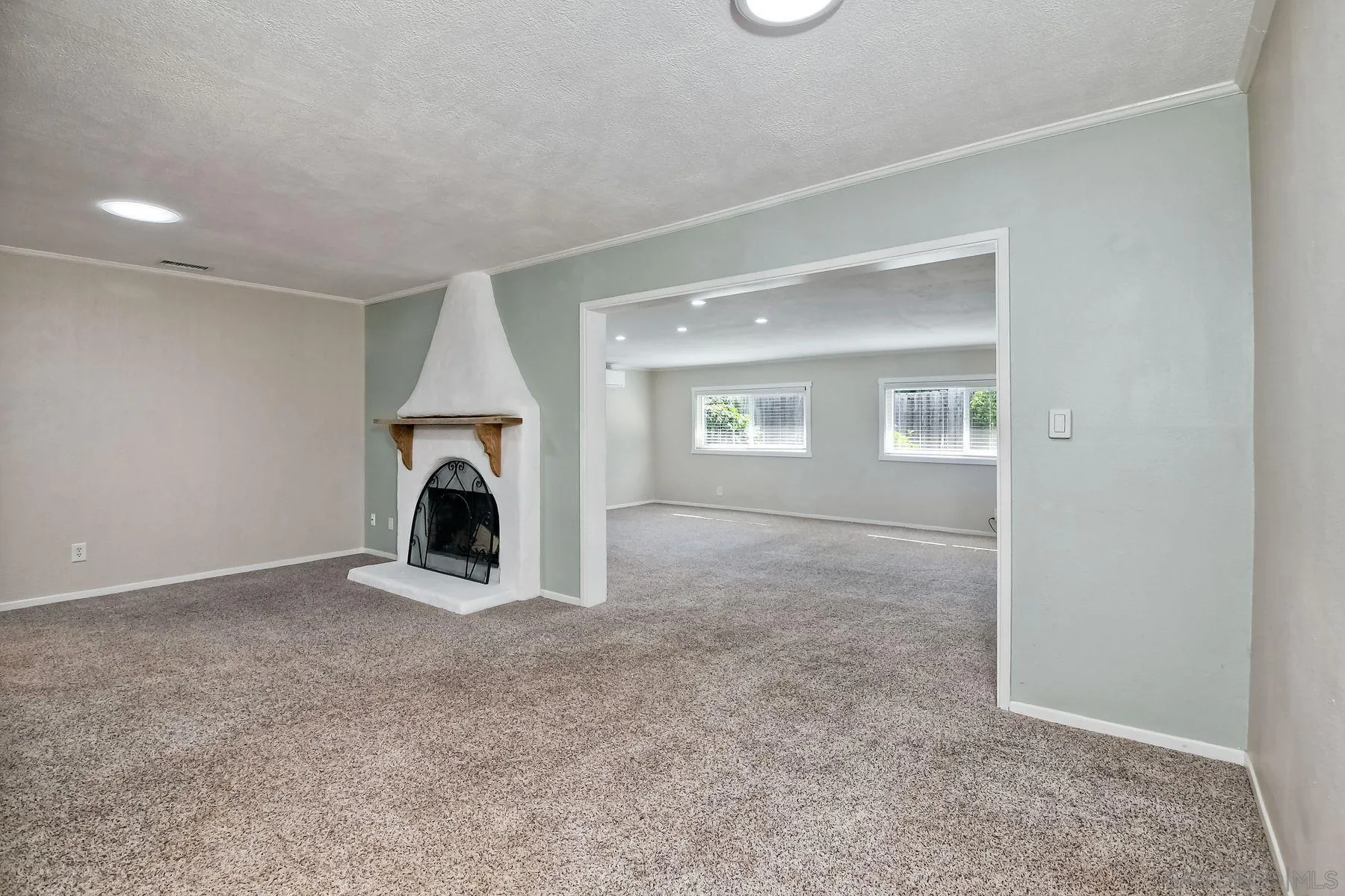 14135 Powers Road Poway, CA 92064 - Photo 17 of 35 an empty room with windows and fireplace