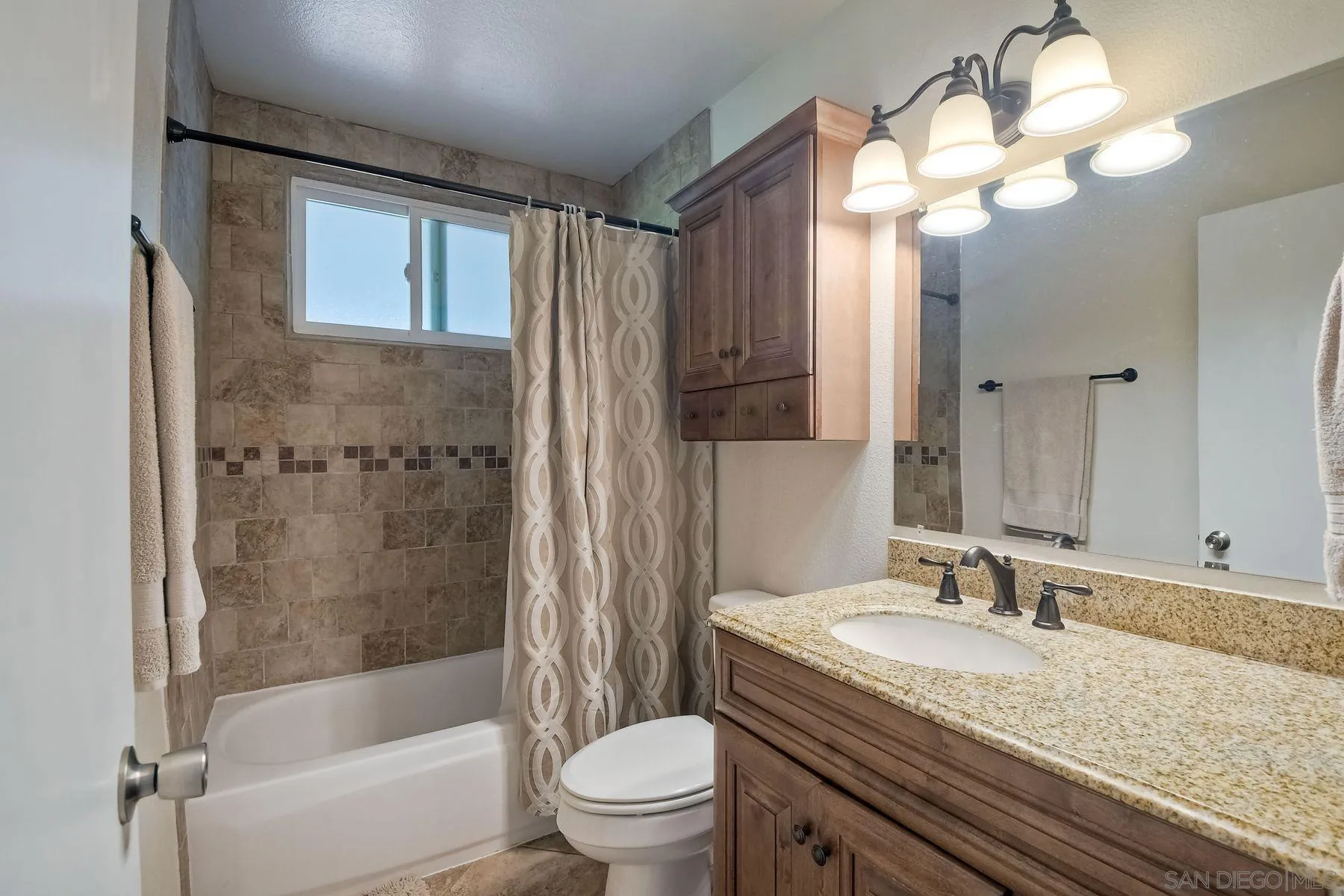 14135 Powers Road Poway, CA 92064 - Photo 23 of 35 a bathroom with a granite countertop sink toilet and shower
