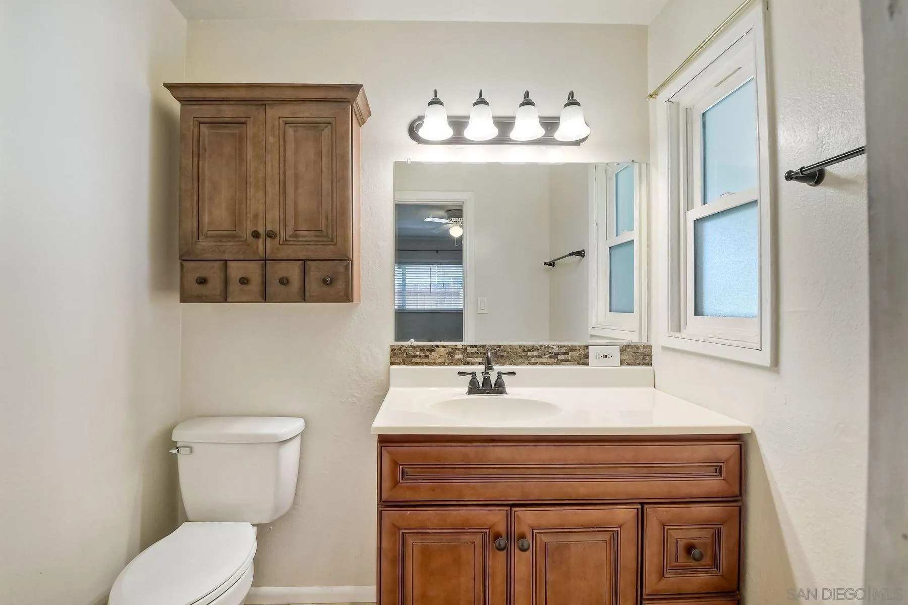 14135 Powers Road Poway, CA 92064 - Photo 28 of 35 a bathroom with a sink vanity and toilet