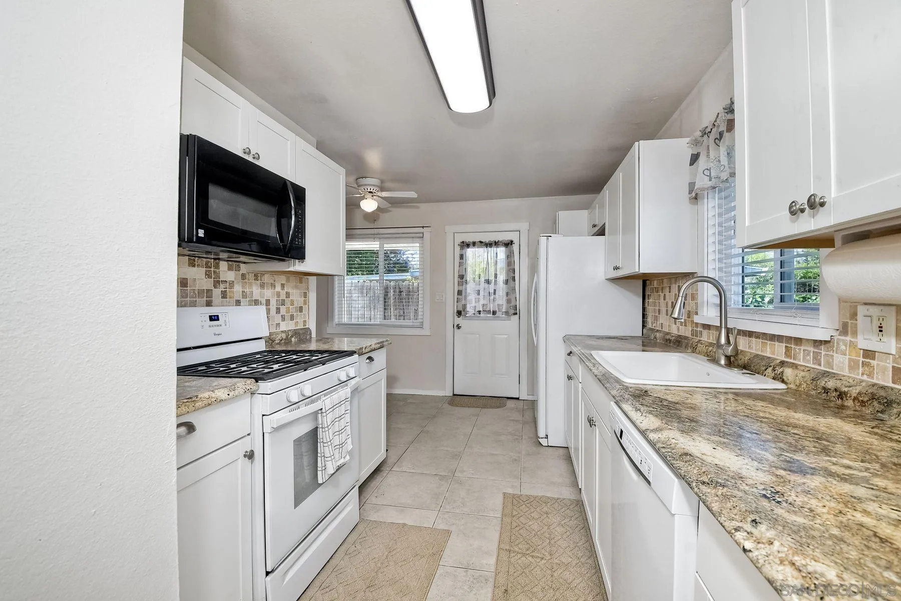 14135 Powers Road Poway, CA 92064 - Photo 5 of 35 a kitchen with stainless steel appliances granite countertop a sink stove and refrigerator