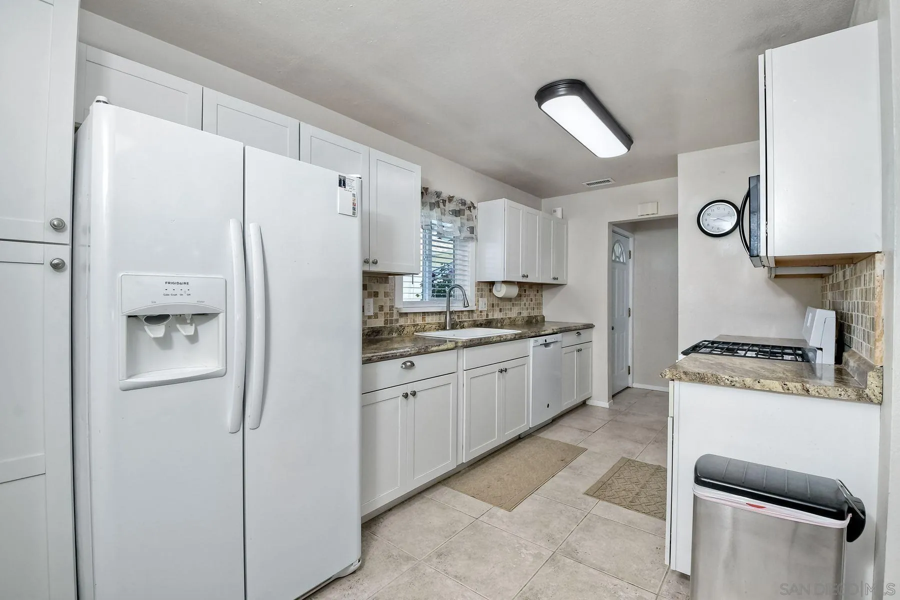 14135 Powers Road Poway, CA 92064 - Photo 7 of 35 a kitchen with stainless steel appliances a refrigerator sink and cabinets