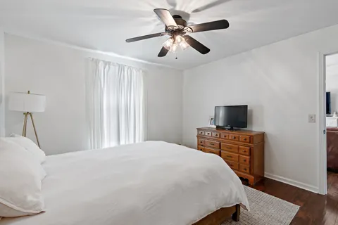 a bedroom with a bed and a flat screen tv