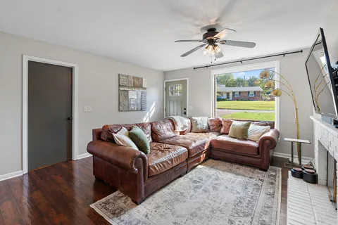 a living room with furniture and a large window