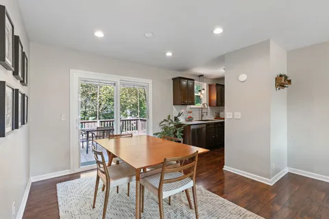 a dining room with furniture and wooden floor