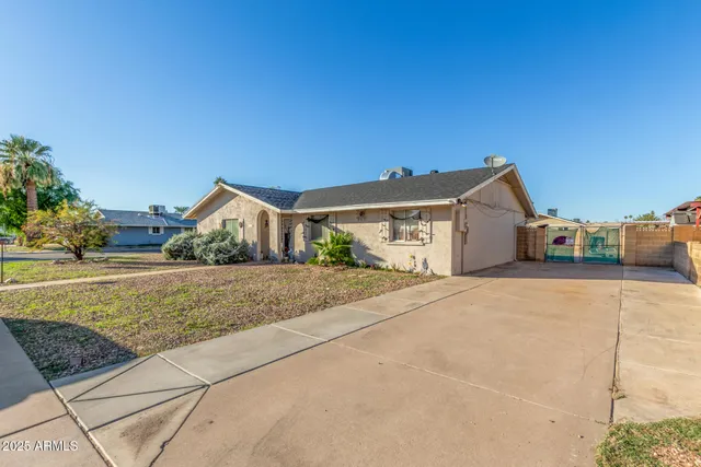 a view of house with garage and yard