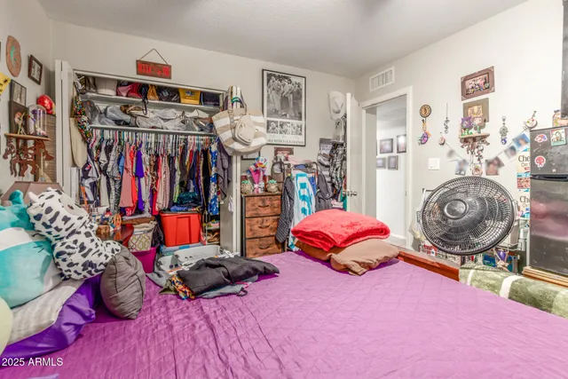 a bed room with a bed and a book shelf