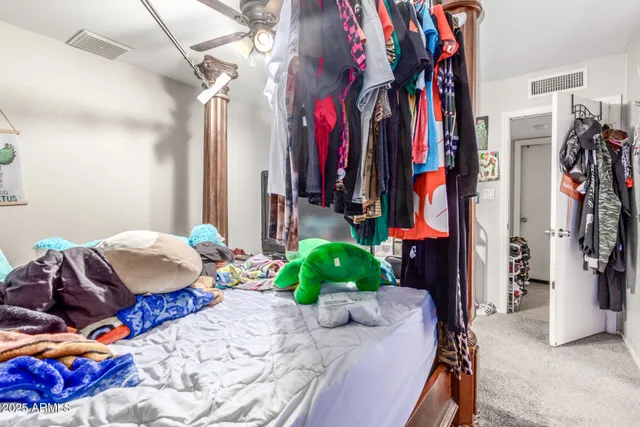 a bedroom with a bed and a view of walk in closet