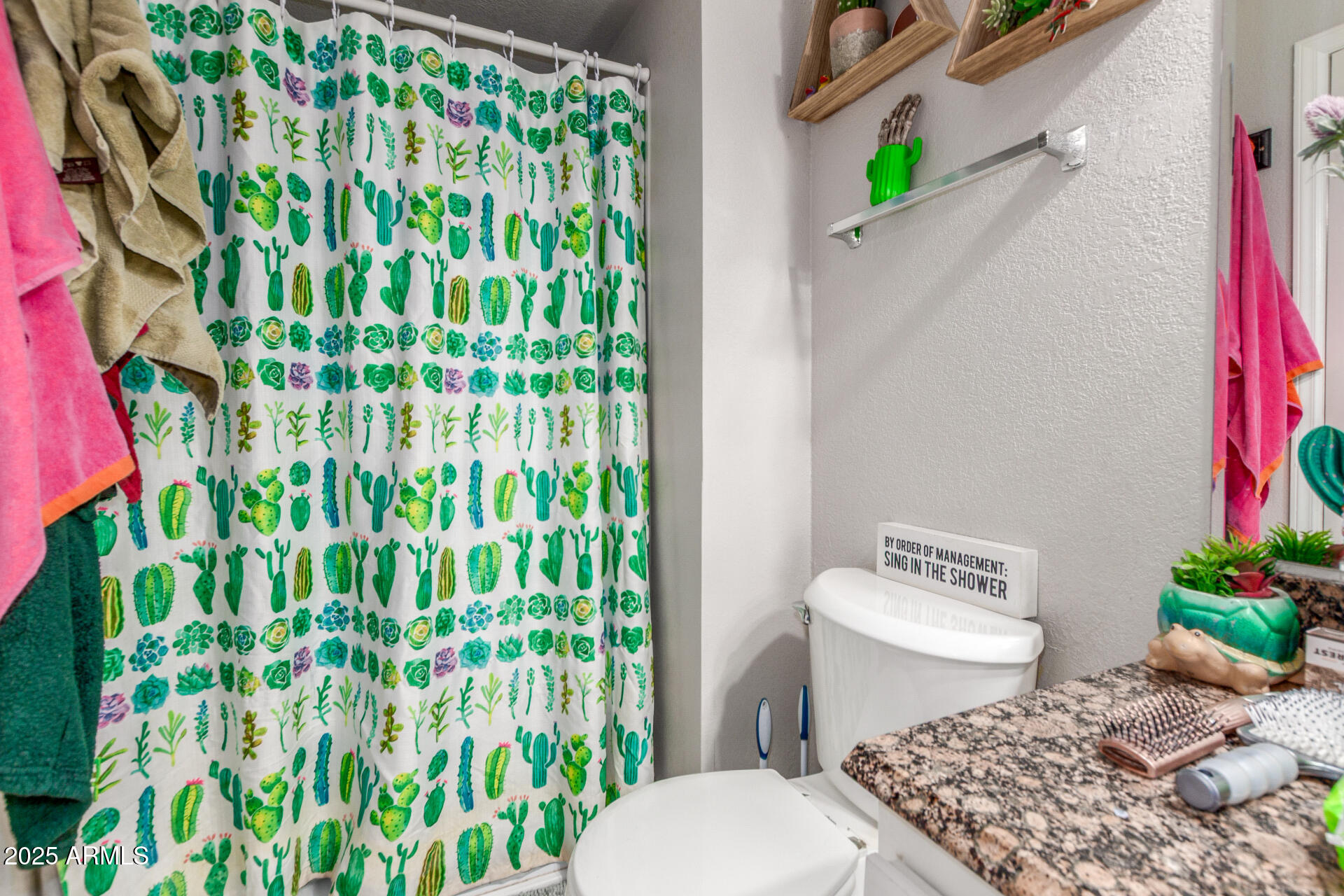 3654 West Shangri-la Road Phoenix, AZ 85029 - Photo 23 of 34 a white toilet sitting next to a shower curtain