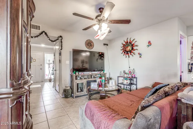 a bedroom with furniture a chandelier and a flat screen tv