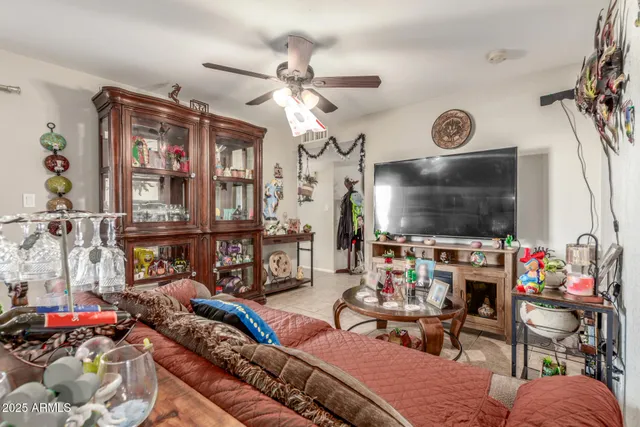 a living room with furniture a flat screen tv and a floor to ceiling window