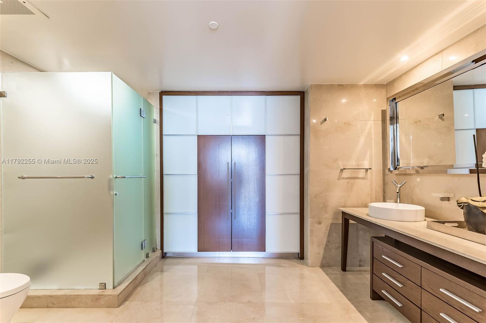 495 Brickell Avenue, Unit 2801 Miami, FL 33131 - Photo 11 of 22 a bathroom with a sink and a mirror