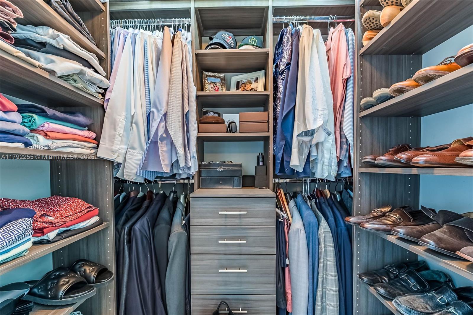495 Brickell Avenue, Unit 2801 Miami, FL 33131 - Photo 13 of 22 a view of walk in closet with clothes and shoes