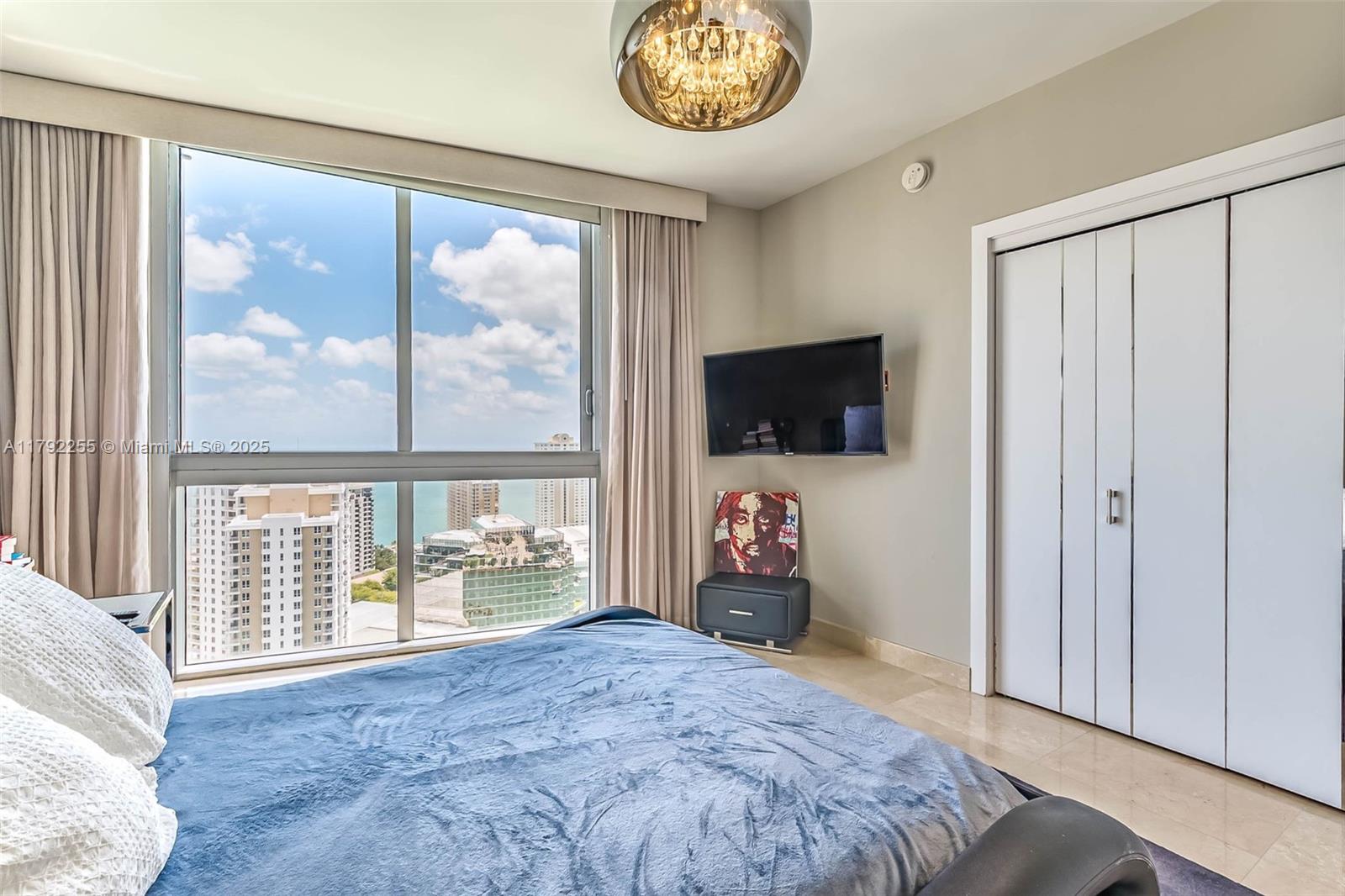 495 Brickell Avenue, Unit 2801 Miami, FL 33131 - Photo 16 of 22 a bedroom with a bed and a television