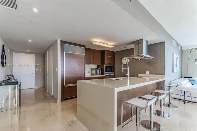 a large kitchen with a table and chairs