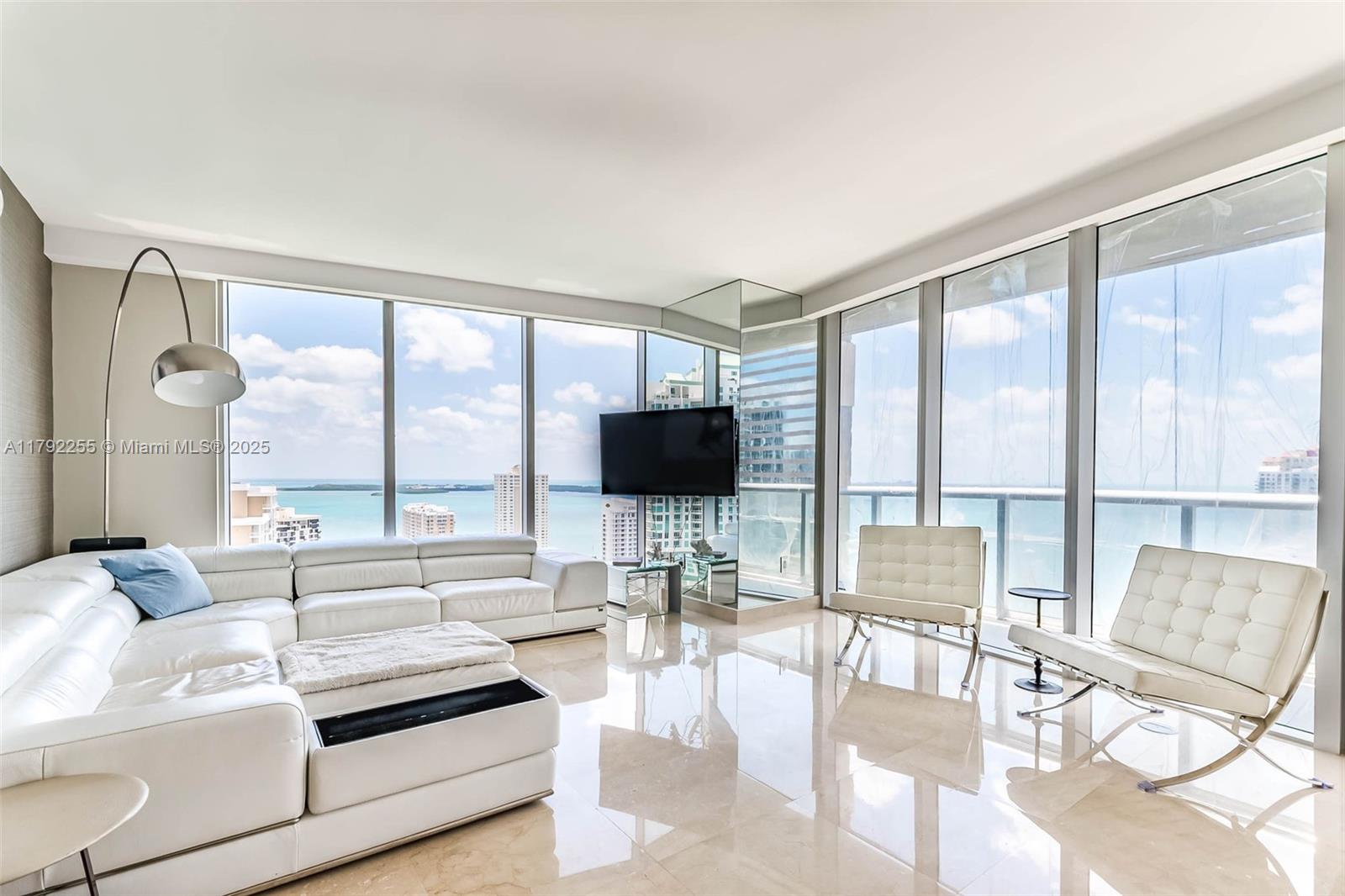 495 Brickell Avenue, Unit 2801 Miami, FL 33131 - Photo 7 of 22 a living room with furniture and a flat screen tv