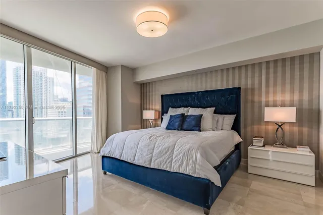 a bedroom with a large bed and a large window