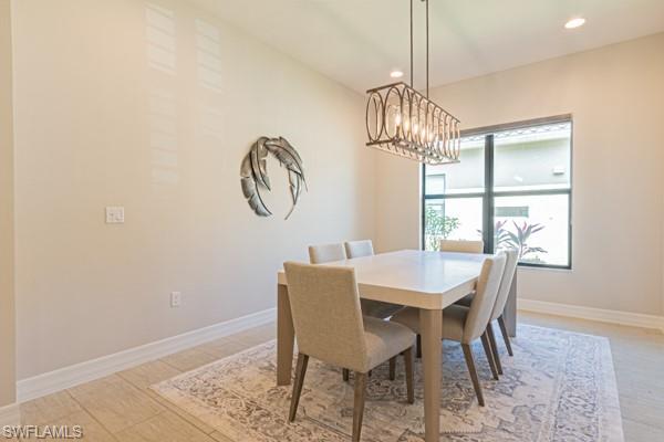 3471 Pacific Drive Naples, FL 34119 - Photo 13 of 29 a view of a dining room with furniture window and wooden floor
