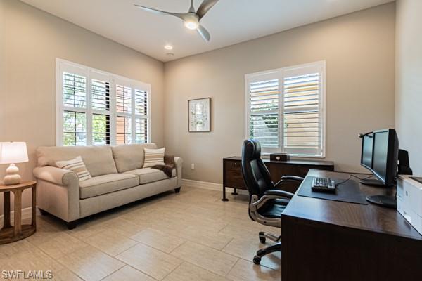 3471 Pacific Drive Naples, FL 34119 - Photo 14 of 29 a livingroom with workspace couch and a window