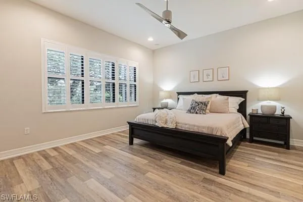 a spacious bedroom with a bed and a window