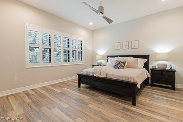 3471 Pacific Drive Naples, FL 34119 - Photo 16 of 29 a spacious bedroom with a bed and a window