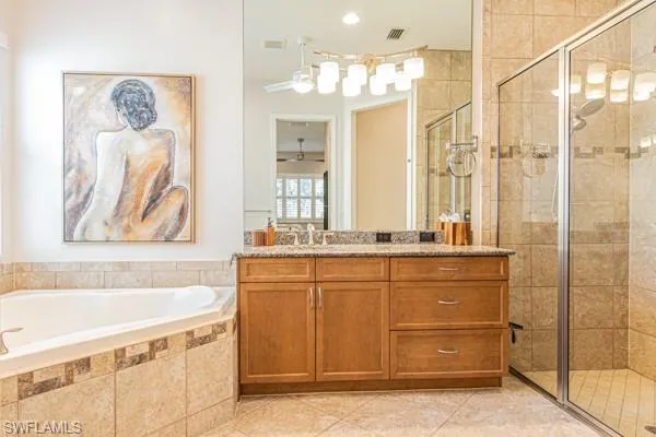 a bathroom with a granite countertop sink a mirror a bathtub and shower