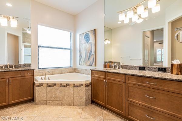 3471 Pacific Drive Naples, FL 34119 - Photo 19 of 29 a bathroom with a tub sink and mirror
