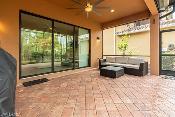 a view of a patio with table and chairs and potted plants