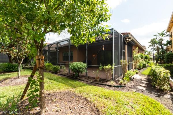 3471 Pacific Drive Naples, FL 34119 - Photo 27 of 29 a view of backyard with a garden and tree