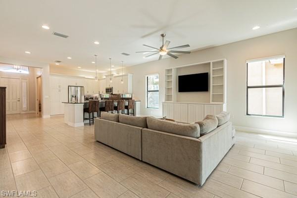 3471 Pacific Drive Naples, FL 34119 - Photo 8 of 29 a living room with furniture and a flat screen tv