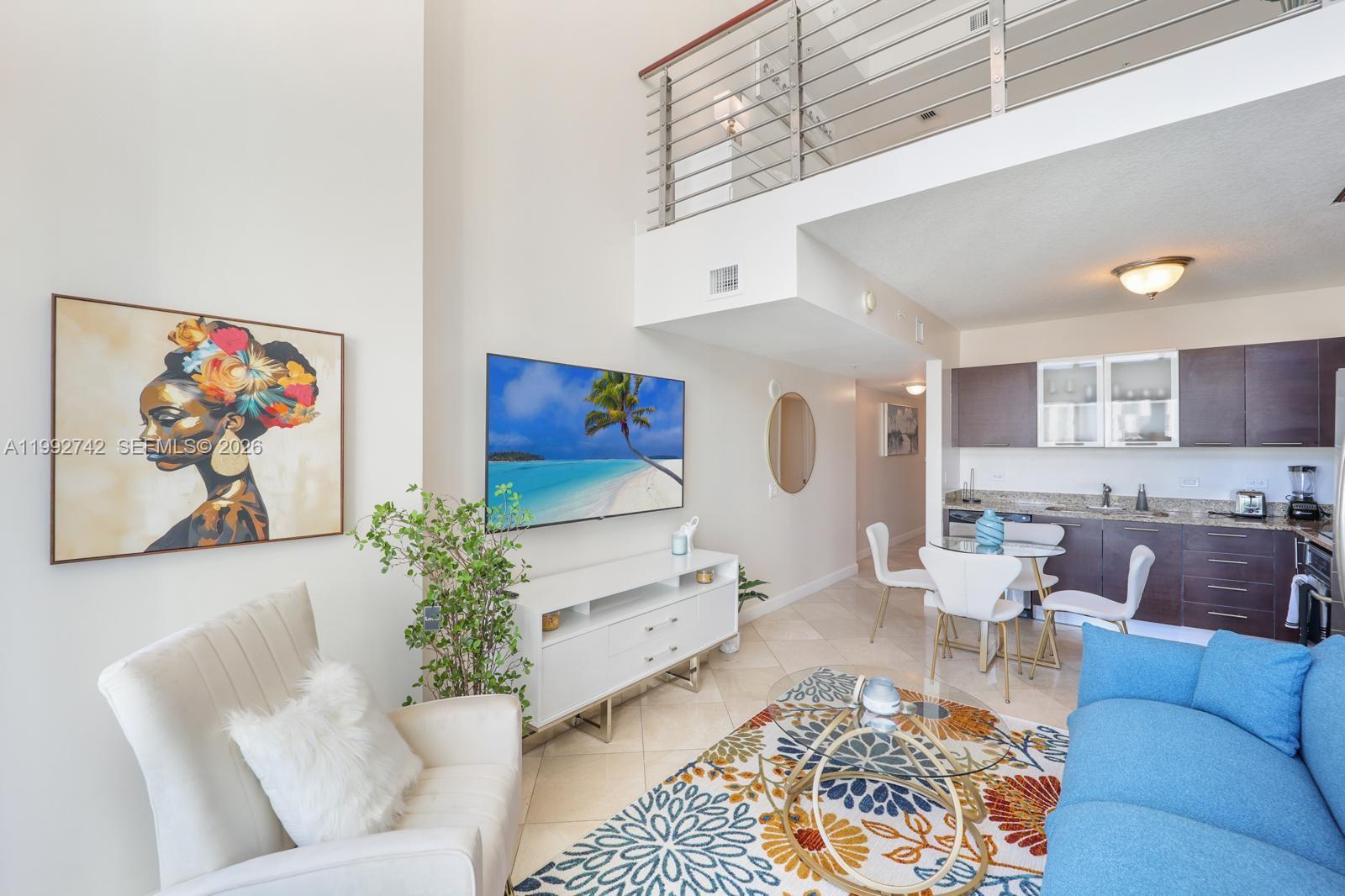 41 Southeast 5th Street, Unit 1505 Miami, FL 33131 - Photo 4 of 16 a living room with furniture and a potted plant
