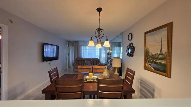 a living room with furniture a rug and a chandelier