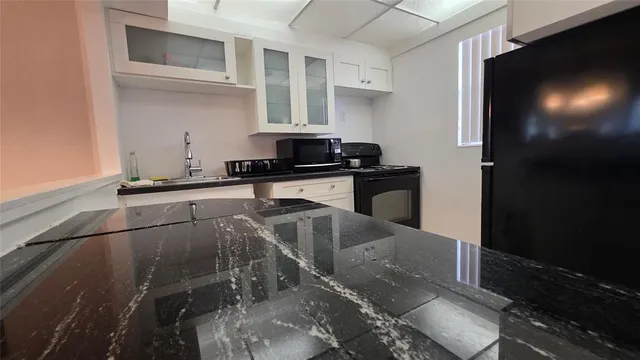 a kitchen with a sink cabinets and appliances