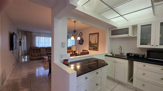 a kitchen that has a sink and cabinets